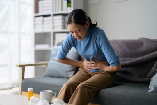 woman-suffering-from-stomach-pain-at-home-2026-03-17-21-42-40-utc (1)
