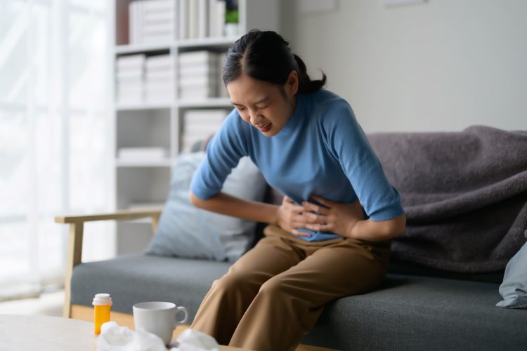 woman-suffering-from-stomach-pain-at-home-2026-03-17-21-42-40-utc (1)
