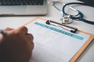 filling-out-health-insurance-form-at-desk-2026-01-08-01-25-42-utc (1)